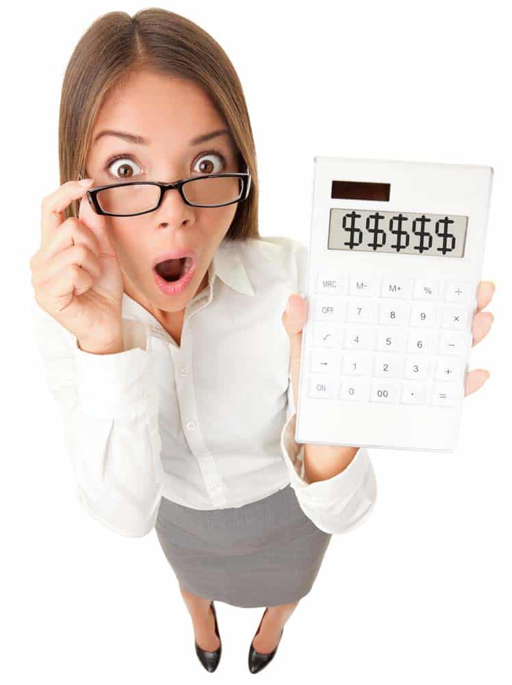 Woman holding a calculator emphasizing the impacts on warehouse profitability